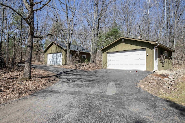 exterior space featuring an outdoor structure and a detached garage