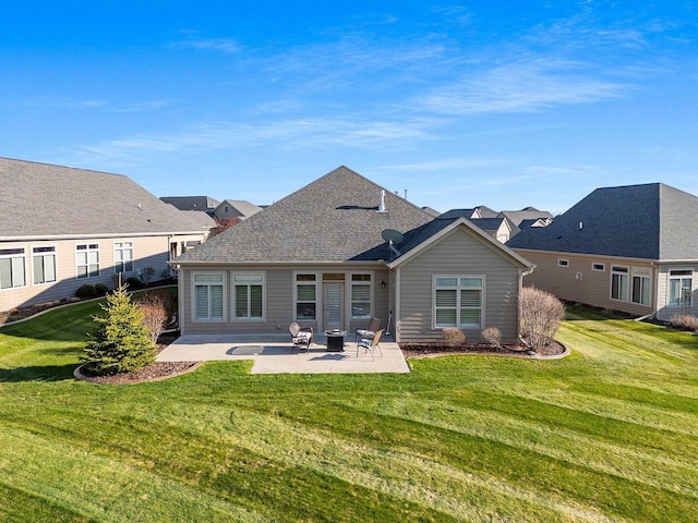 back of property featuring a yard and a patio