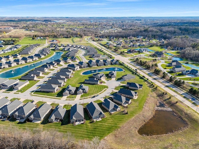 bird's eye view with a residential view and a water view