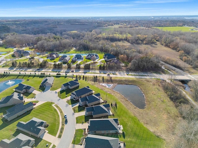 drone / aerial view with a water view and a residential view