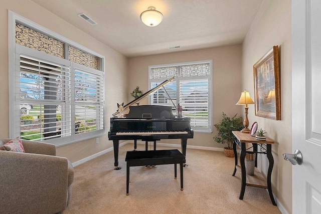 living area featuring baseboards, a wealth of natural light, and visible vents