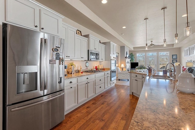 kitchen featuring a ceiling fan, a sink, open floor plan, stainless steel appliances, and recessed lighting