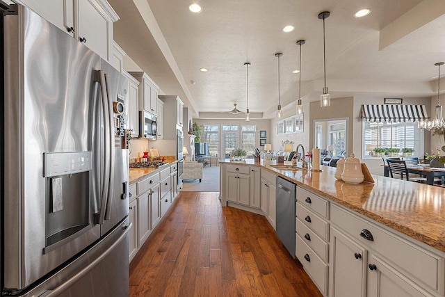 kitchen featuring recessed lighting, a sink, appliances with stainless steel finishes, and open floor plan