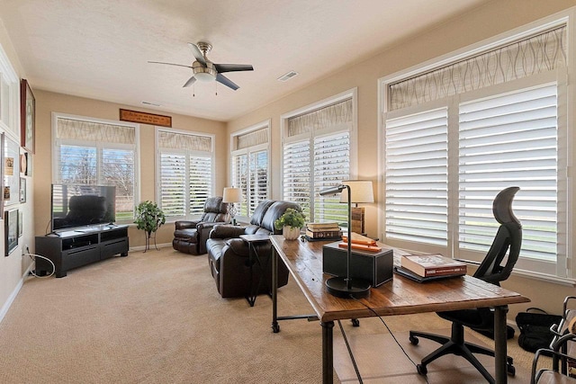 office area featuring carpet floors, a ceiling fan, and visible vents