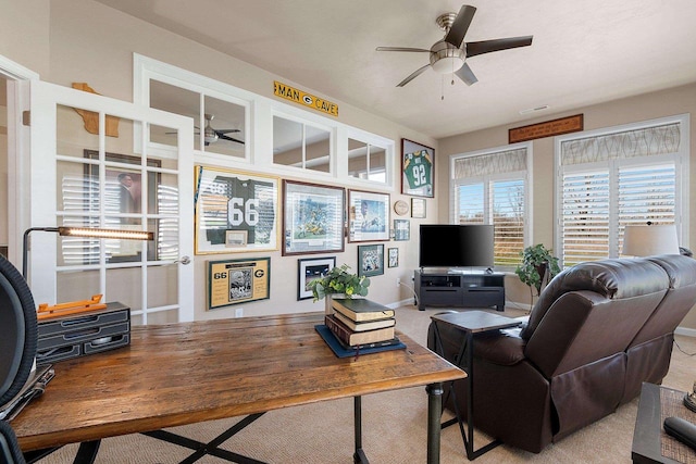 living room featuring visible vents, a ceiling fan, and light colored carpet