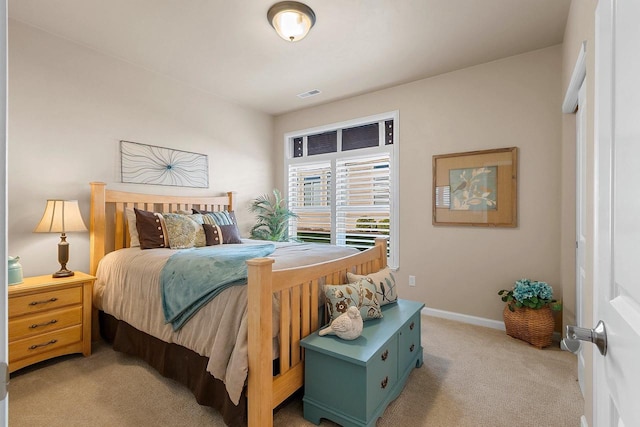 bedroom featuring light colored carpet, baseboards, and visible vents