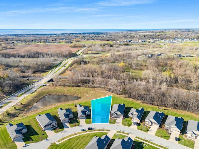 drone / aerial view with a water view and a residential view