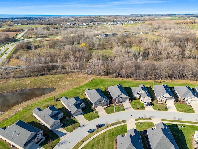 drone / aerial view with a water view and a residential view