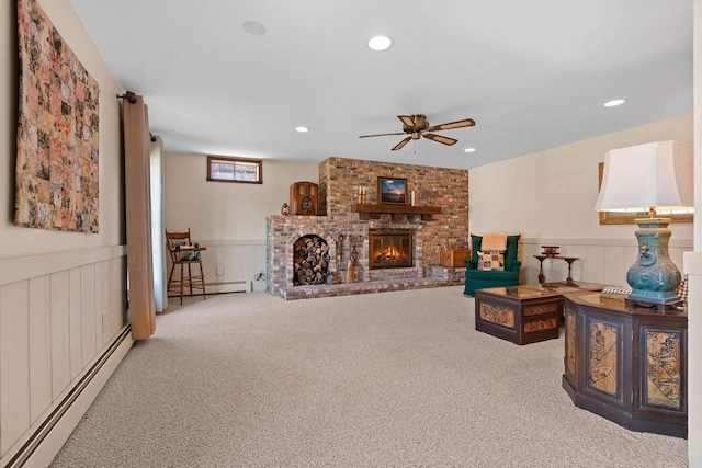 living room featuring carpet flooring, ceiling fan, and a baseboard radiator