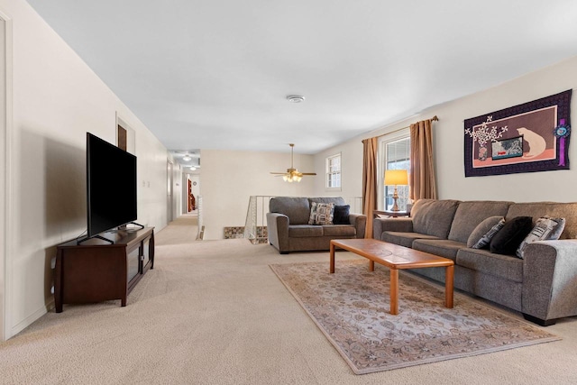 living area with ceiling fan and carpet flooring