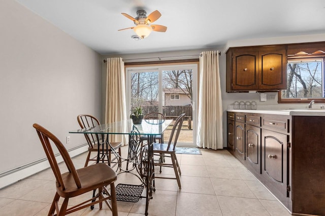 dining area with a ceiling fan and light tile patterned floors