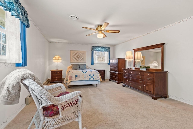 bedroom with baseboards, a ceiling fan, and light carpet