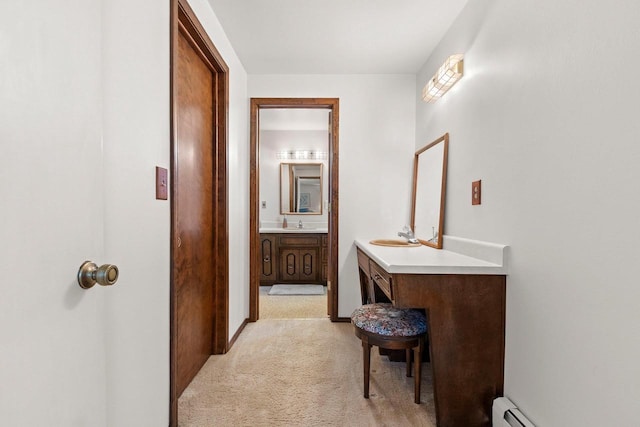 bathroom with a baseboard heating unit and vanity