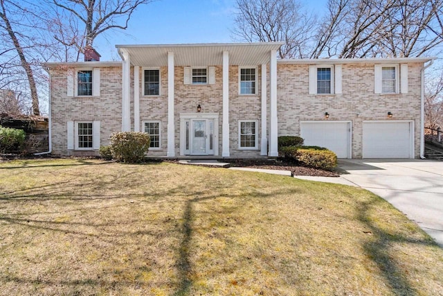 neoclassical home featuring concrete driveway, brick siding, a front lawn, and a garage