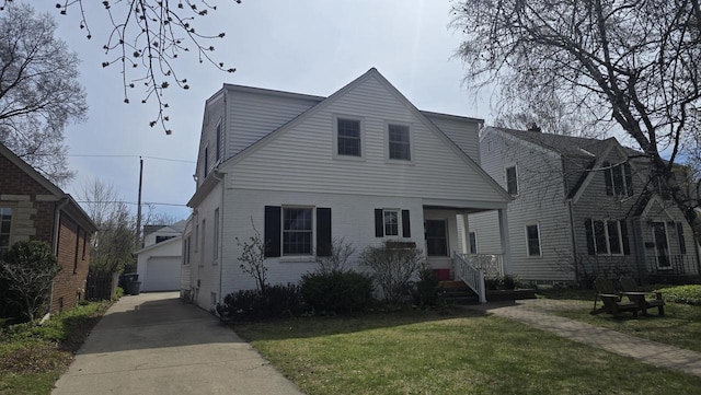 5030 N Kent Ave, Milwaukee, WI 53217 - view of front facade with a detached garage, brick siding, an outbuilding, and a front lawn