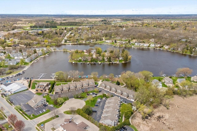 drone / aerial view with a water view and a residential view