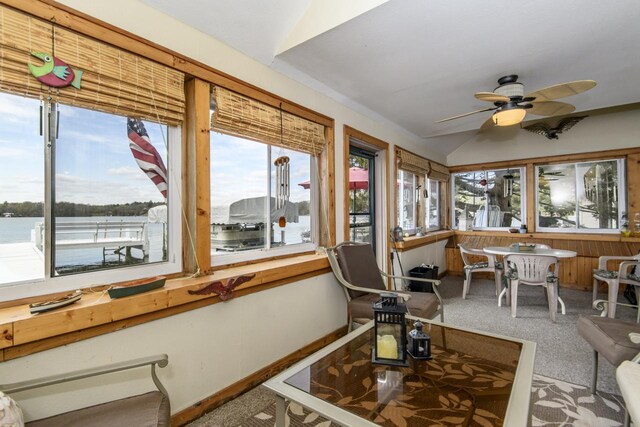 sunroom / solarium featuring carpet and vaulted ceiling