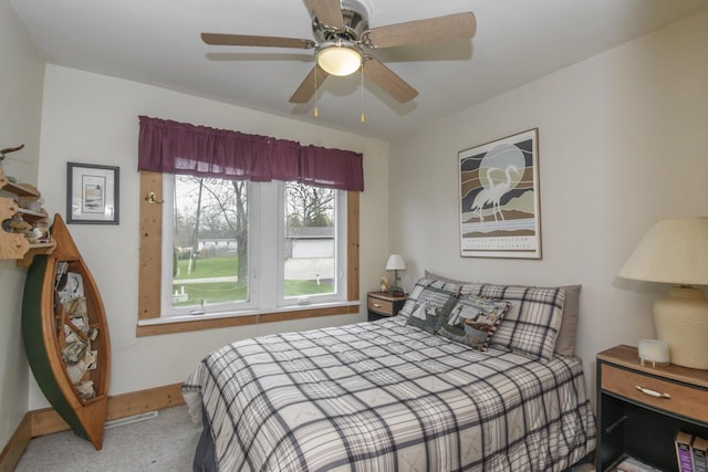 bedroom with baseboards, ceiling fan, and carpet