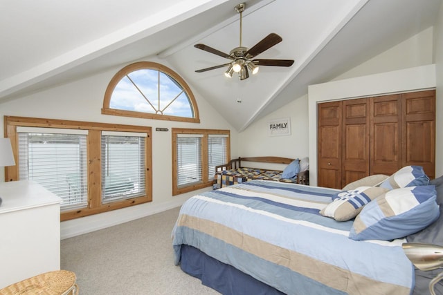 bedroom featuring carpet floors, ceiling fan, lofted ceiling with beams, and a closet