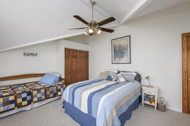carpeted bedroom featuring vaulted ceiling with beams, a ceiling fan, and a closet