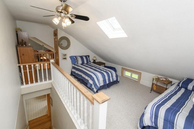 bedroom featuring ceiling fan and vaulted ceiling with skylight