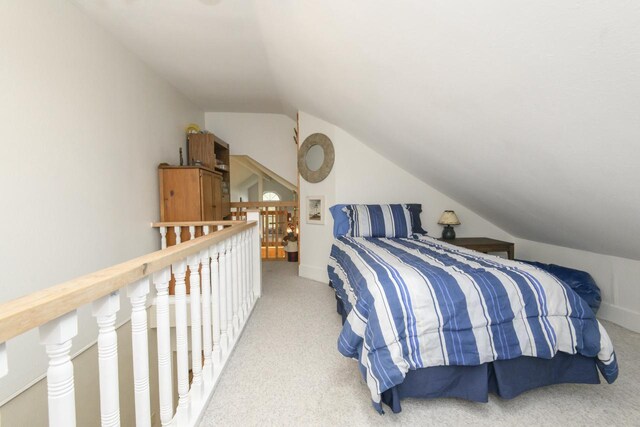 carpeted bedroom with vaulted ceiling