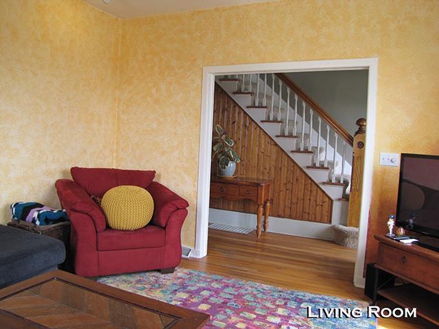 living area with stairs and wood finished floors
