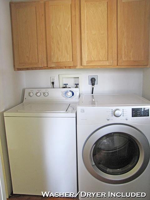 laundry room with washing machine and dryer and cabinet space