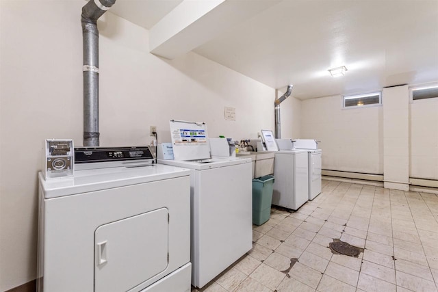 common laundry area with washer and clothes dryer and a baseboard radiator