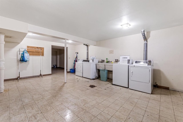 common laundry area featuring washing machine and clothes dryer and baseboards