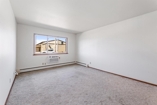 spare room featuring baseboards, carpet flooring, a wall unit AC, and baseboard heating
