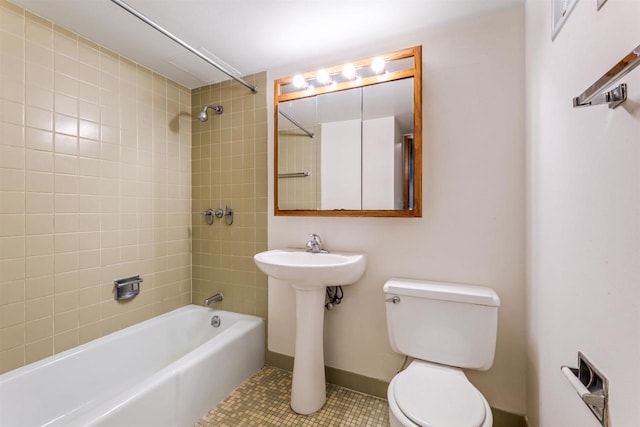 full bathroom with toilet, tile patterned floors, tub / shower combination, and a sink