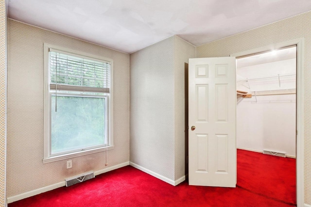 S9073 Timbercrest Trl, Prairie Du Sac, WI 53578 - unfurnished bedroom featuring carpet floors, a closet, baseboards, and a spacious closet