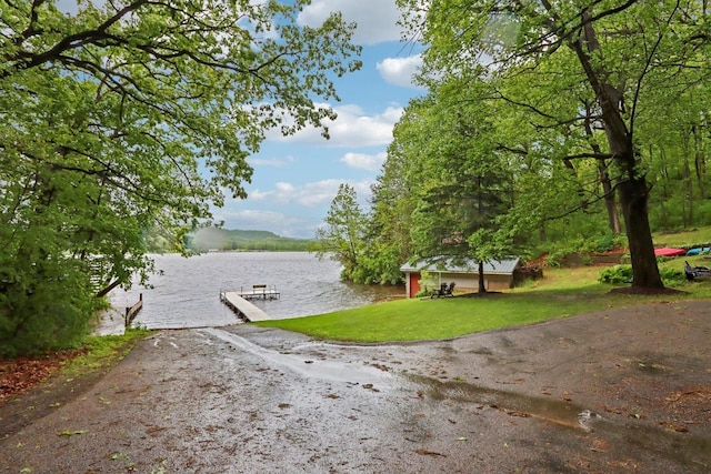 S9073 Timbercrest Trl, Prairie Du Sac, WI 53578 - exterior space with a water view, a boat dock, and a lawn