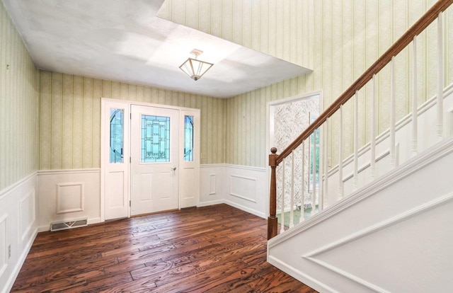 S9073 Timbercrest Trl, Prairie Du Sac, WI 53578 - entrance foyer with wallpapered walls, dark wood-style floors, wainscoting, and stairs
