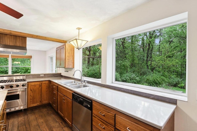 S9073 Timbercrest Trl, Prairie Du Sac, WI 53578 - kitchen with appliances with stainless steel finishes, a sink, dark wood-type flooring, brown cabinetry, and decorative light fixtures