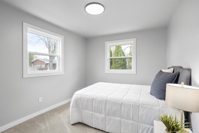 bedroom featuring baseboards and carpet