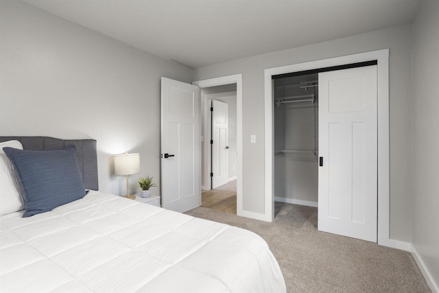 bedroom with a closet, baseboards, and carpet flooring