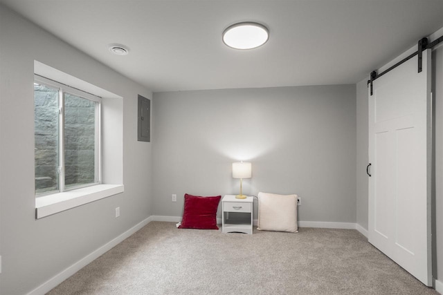 unfurnished room featuring carpet floors, baseboards, electric panel, and a barn door