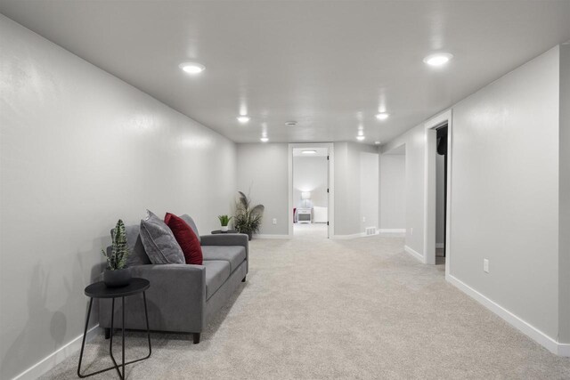 interior space with baseboards, light carpet, recessed lighting, and visible vents