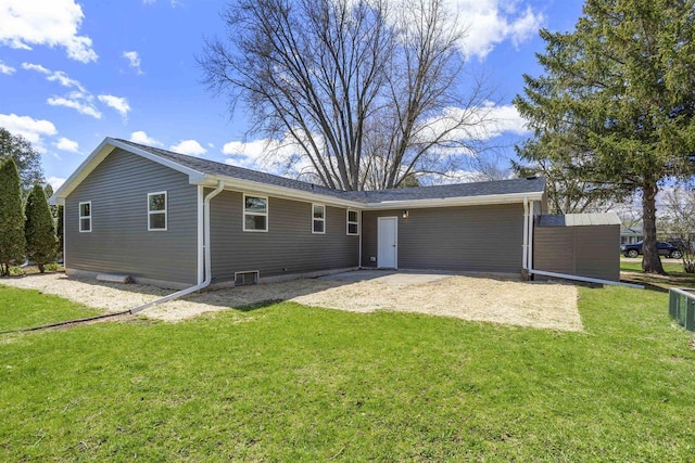 rear view of house featuring a patio and a yard