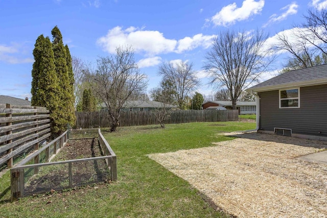view of yard featuring a fenced backyard and a vegetable garden