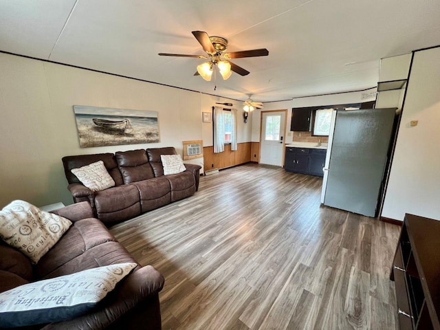 living room featuring a ceiling fan and wood finished floors