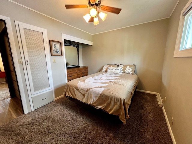 carpeted bedroom with baseboards, ornamental molding, and ceiling fan