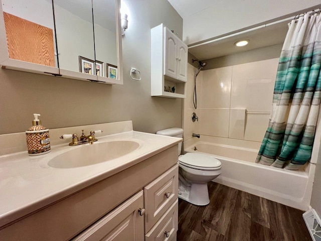 full bath with shower / bath combo, vanity, toilet, wood finished floors, and visible vents