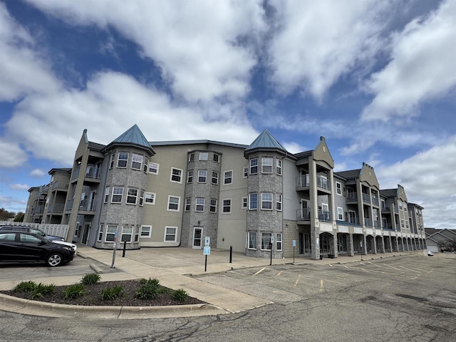 view of building exterior with uncovered parking