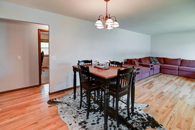 511 Linda Rd, Mount Horeb, WI 53572 - dining space featuring light wood-style floors, a chandelier, and baseboards