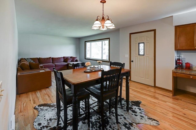 511 Linda Rd, Mount Horeb, WI 53572 - dining room featuring light wood-type flooring, baseboards, and a chandelier