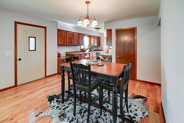 511 Linda Rd, Mount Horeb, WI 53572 - dining space with light wood finished floors, baseboards, and a chandelier