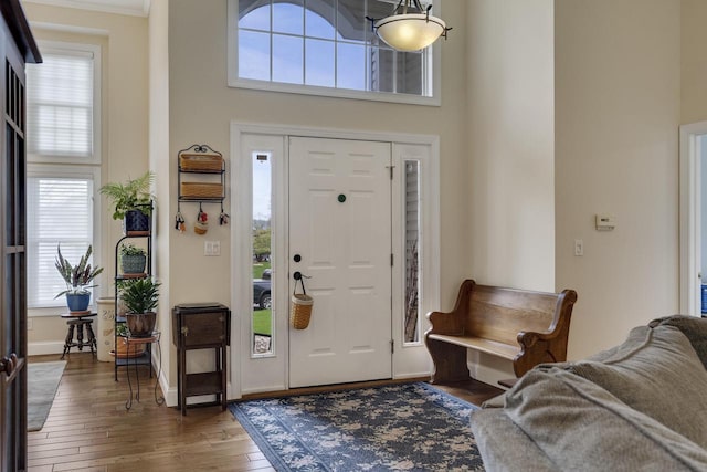 entryway featuring baseboards and hardwood / wood-style floors